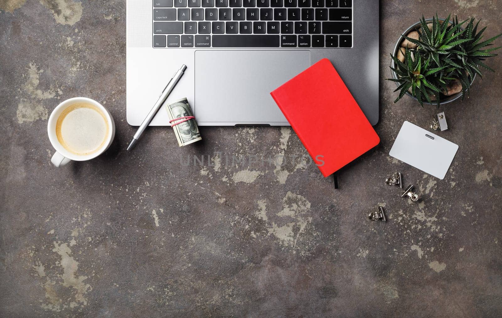 Laptop and office supplies on concrete background. Online shopping concept. Flat lay.