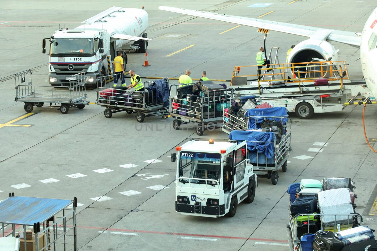 Prague, Czech Republic - July 28th, 2018: Ground personnel loading luggage into Tailwind Boeing 737-400 at Ruzyne, Vaclav Havel Airport.