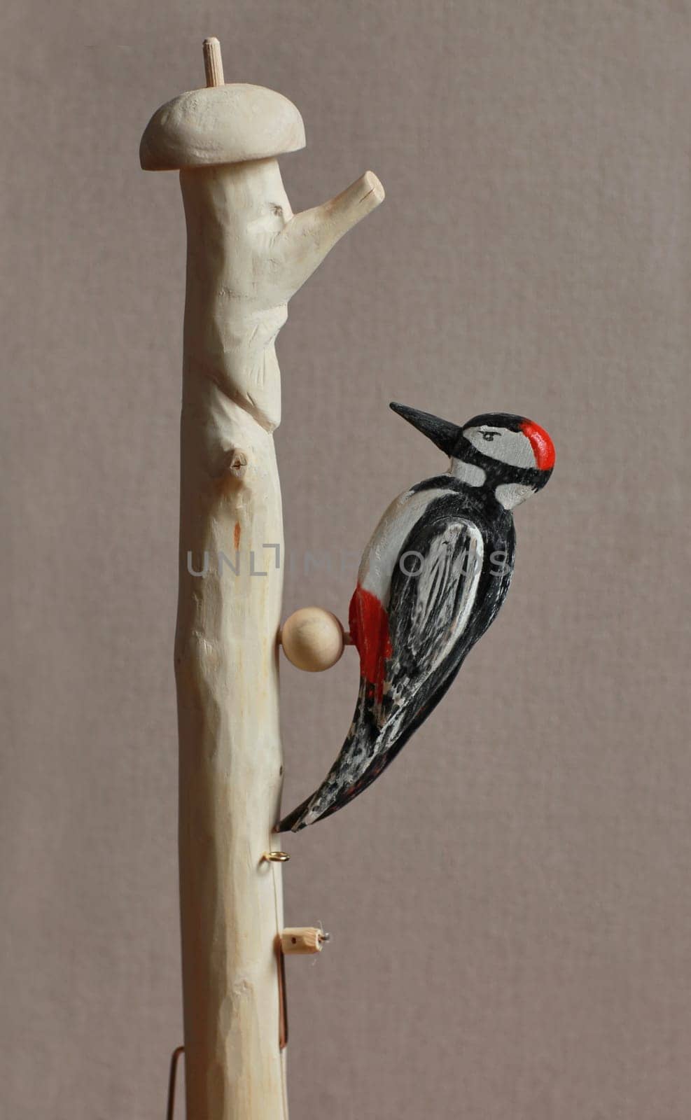 red-headed woodpecker figurine wooden toy close-up