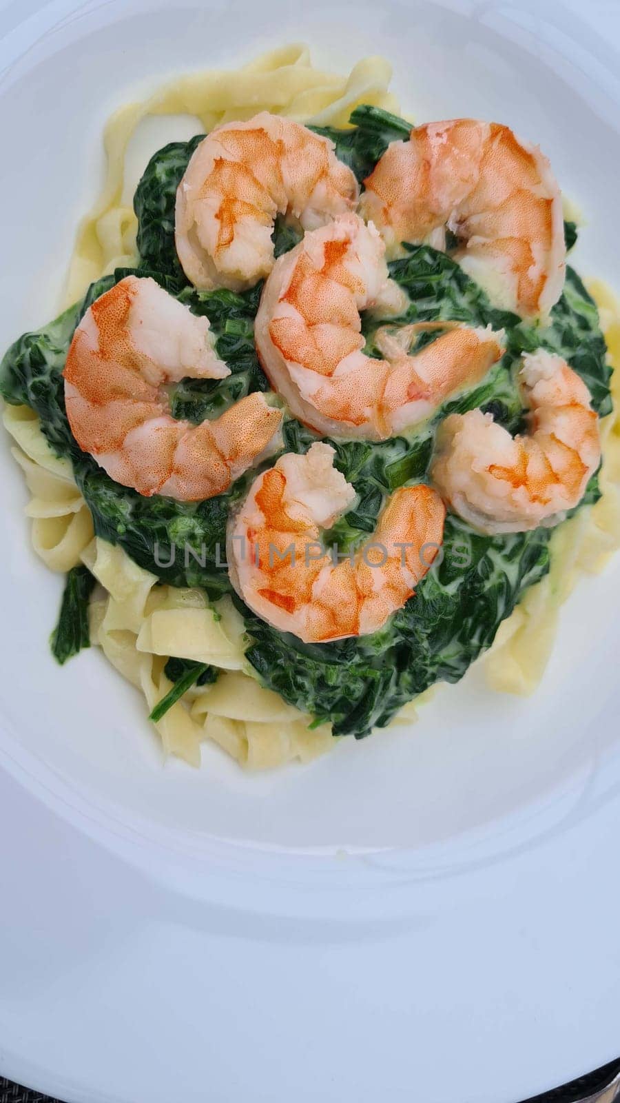 Shrimp Fetticcin Pasta. Italian pasta with shrimp and cream Alfredo sauce, top view, copy space.