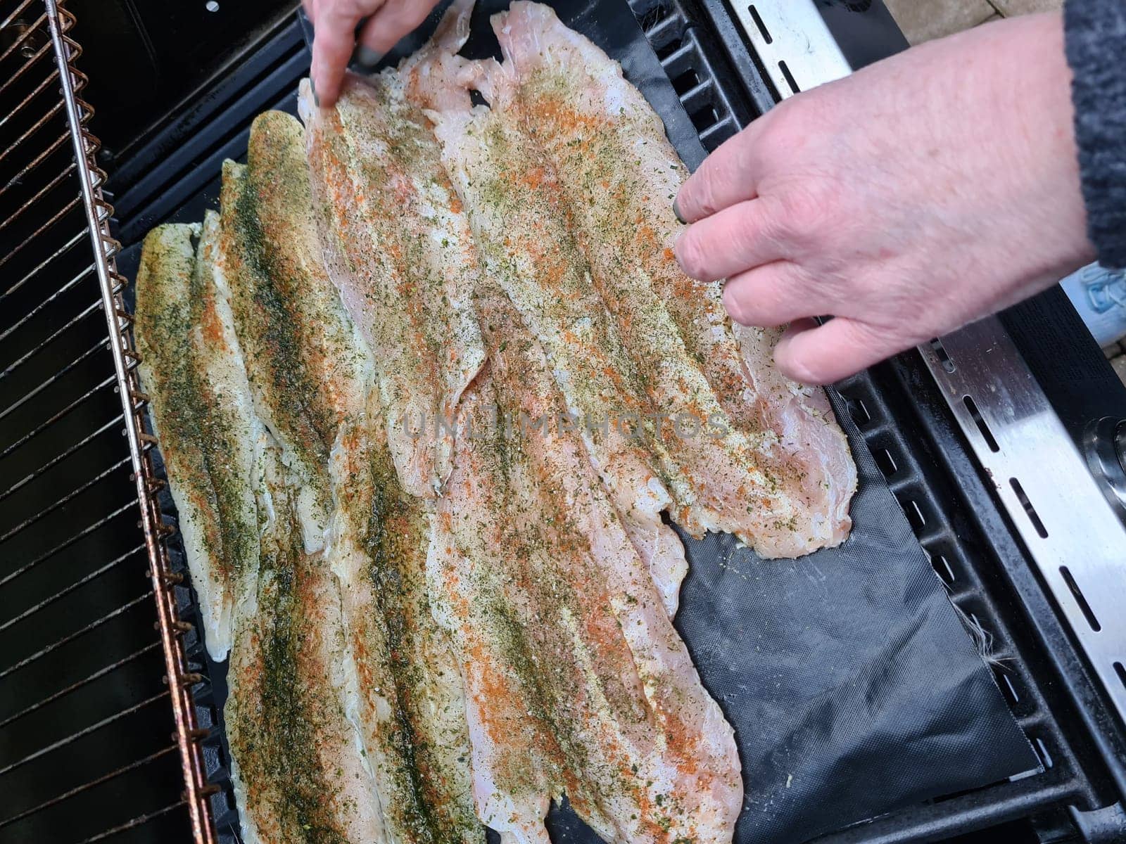 Professional chef cooking fish on a barbeque