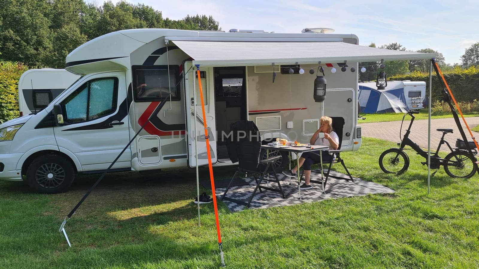 A new mobile home with awning and table and chairs