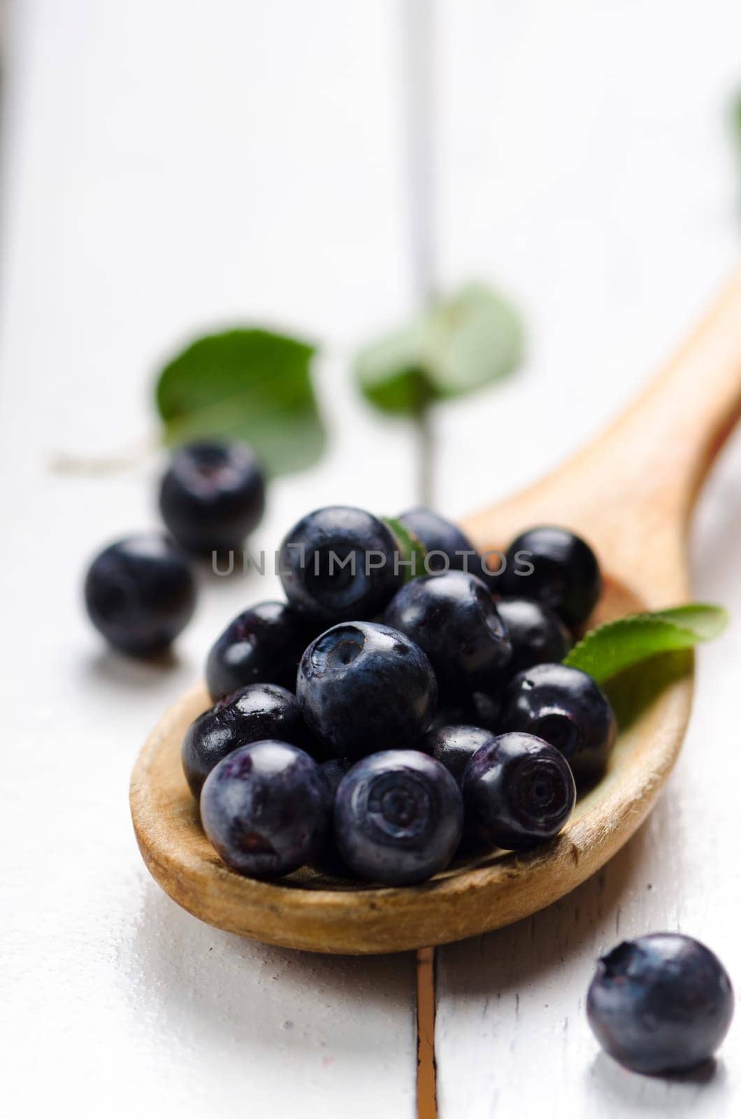 Fresh blueberries in wooden spoon