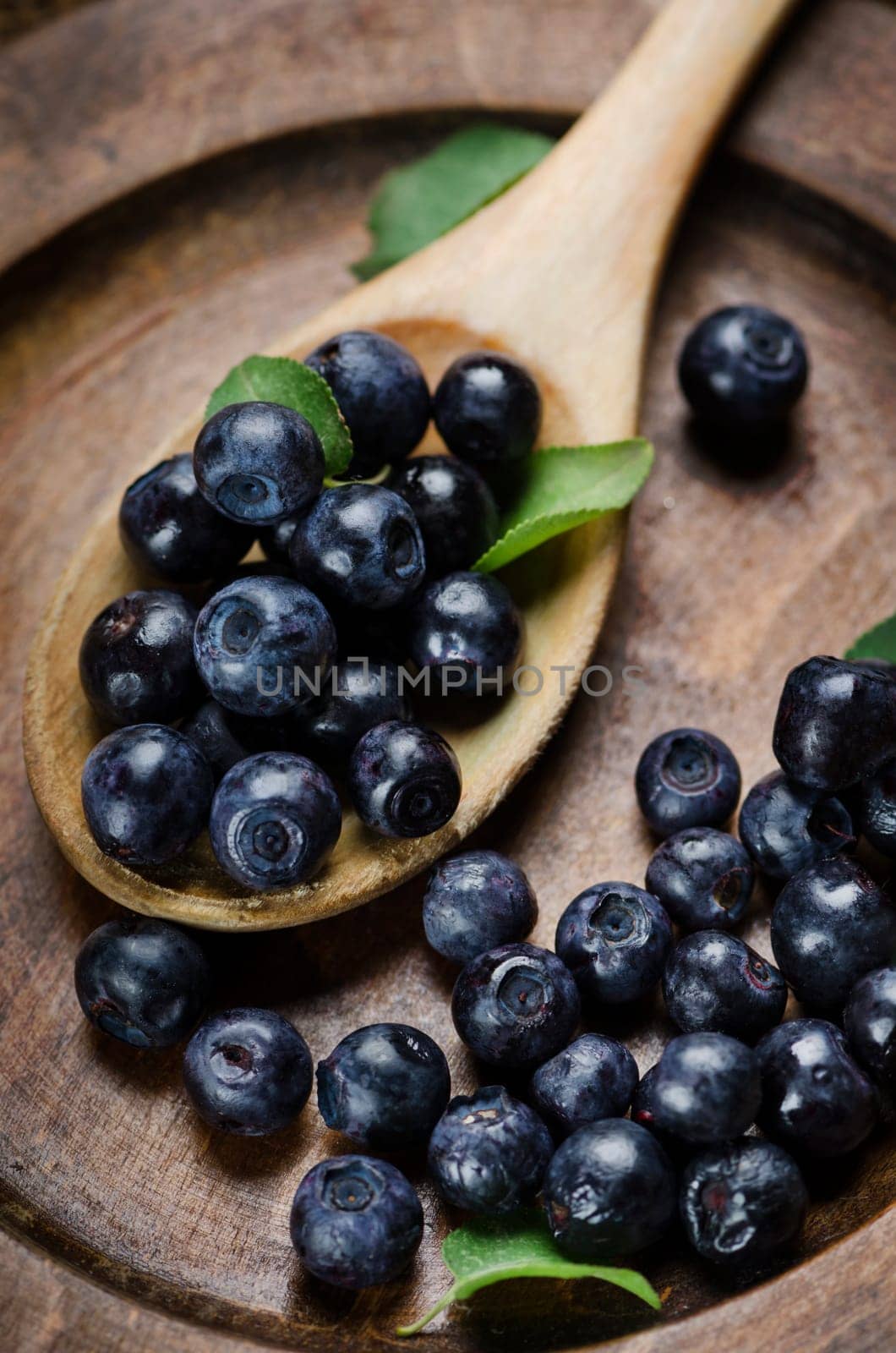 Fresh blueberries in wooden spoon