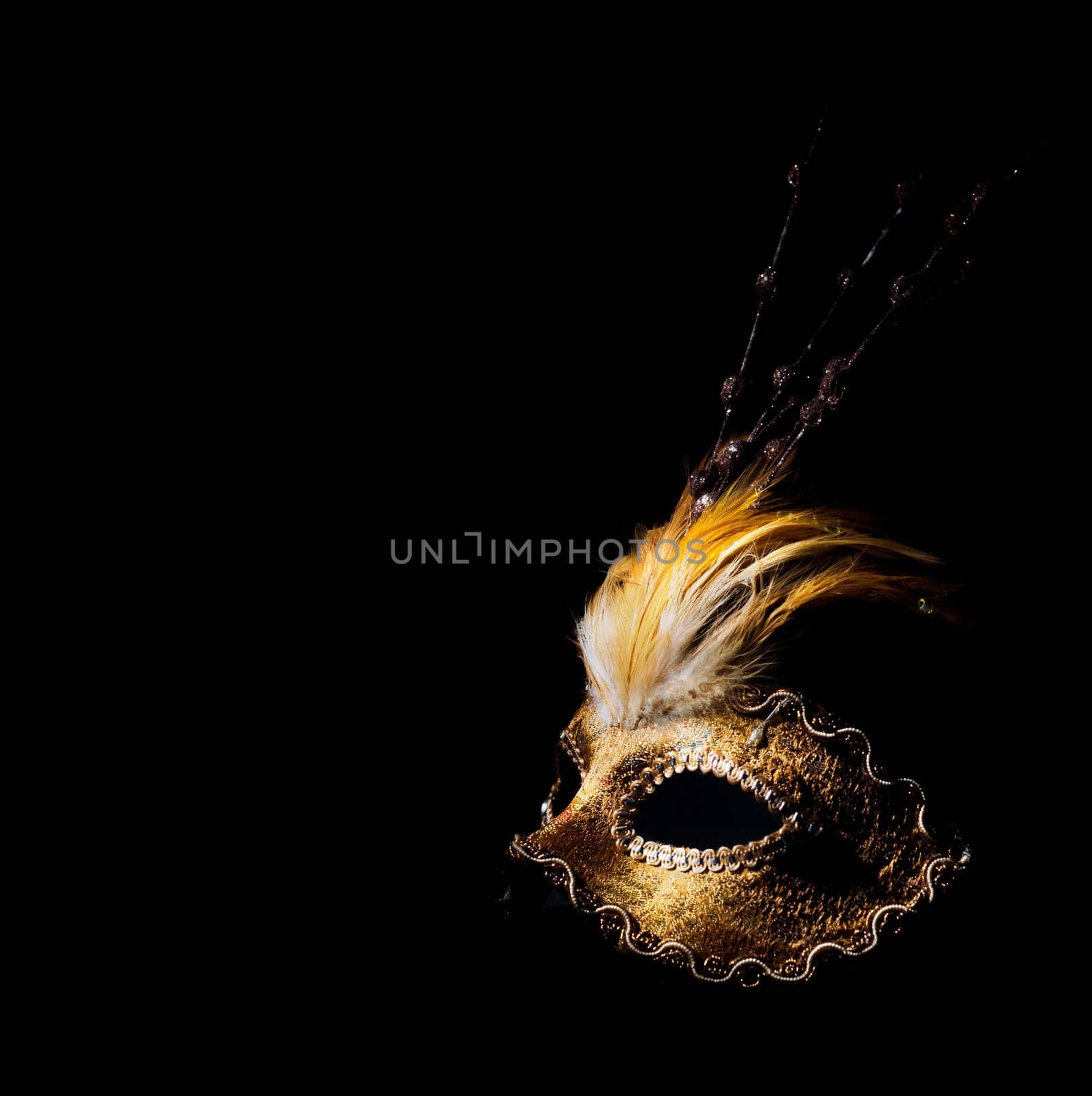Golden venetian mask over black background