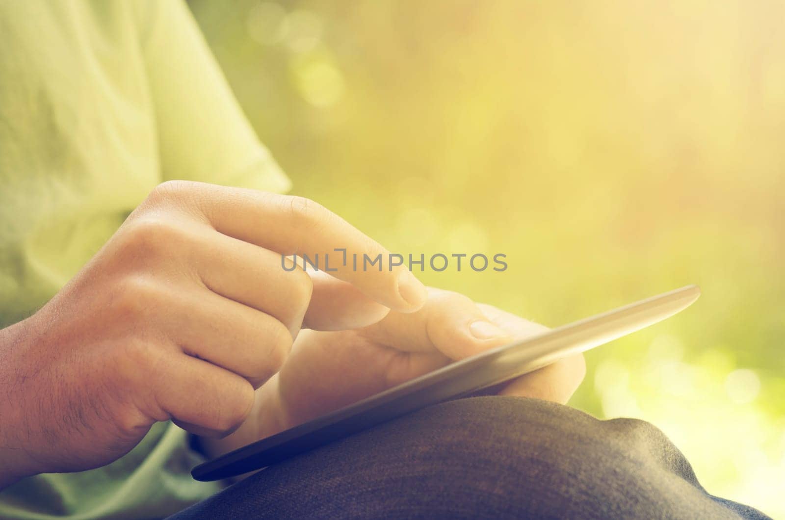 Man holding tablet in the park