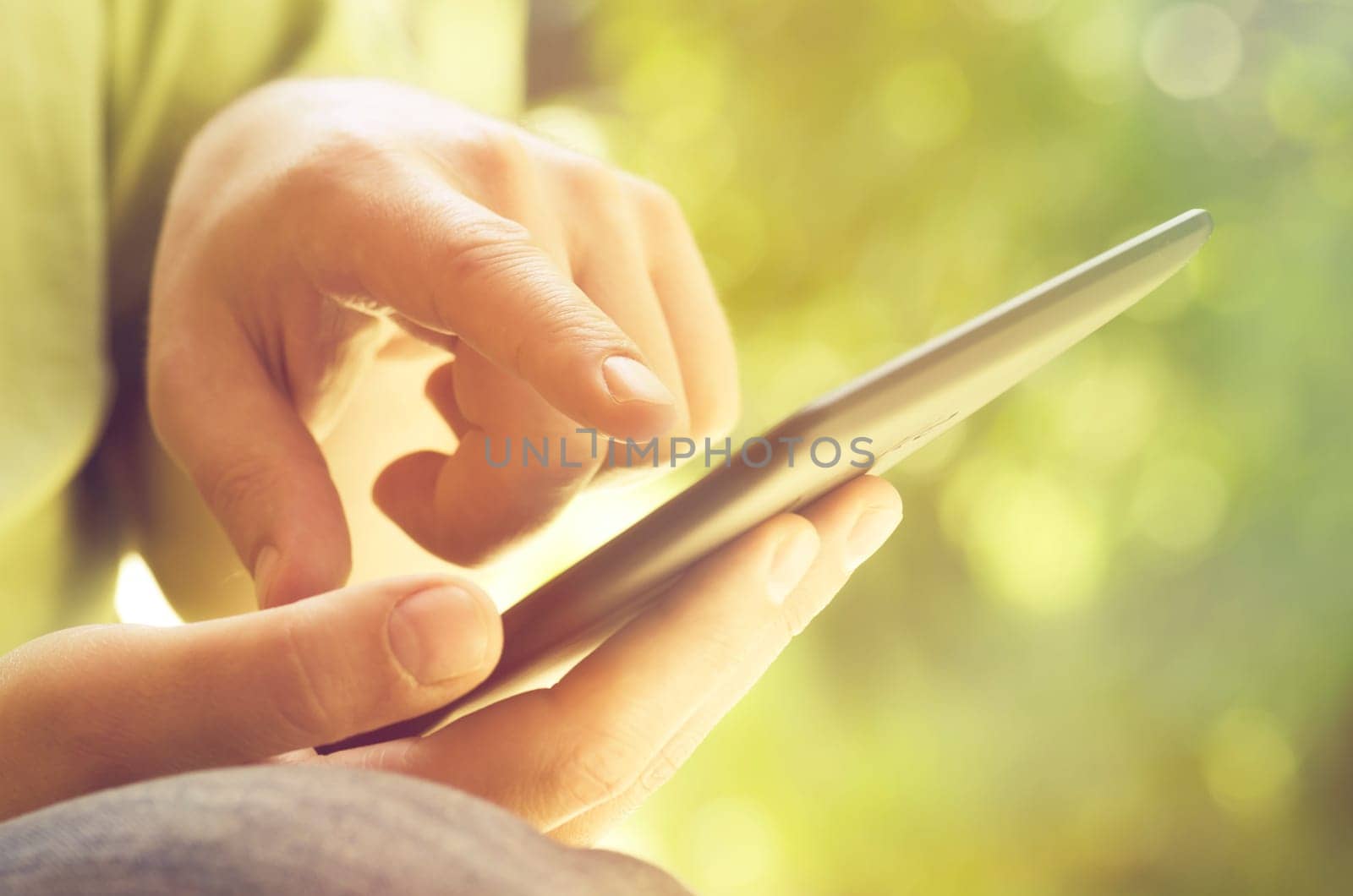 Man holding tablet in the park