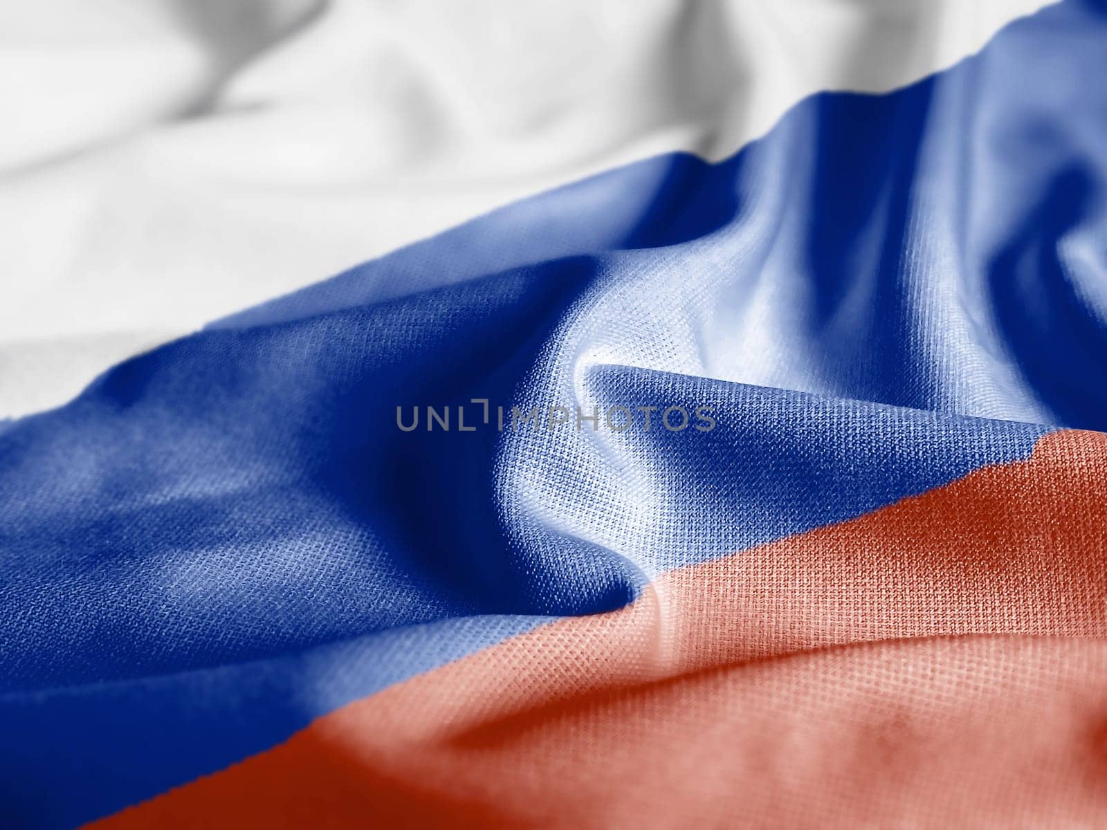 Close up of the Russia flag on a ruffled mesh fabric. Curves and folds of the satin fabric with texture. Selective focus and depth of field. Democracy and politics.
