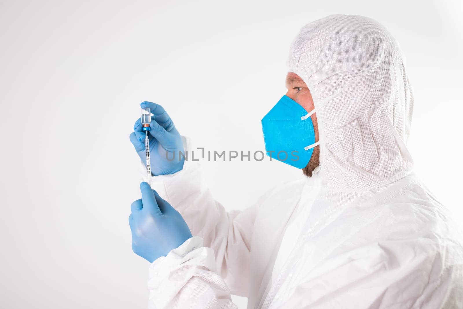 COVID-19 coronavirus vaccine. Vaccination concept. Doctor's hand in blue gloves hold medicine vaccine vial bottle and syringe.