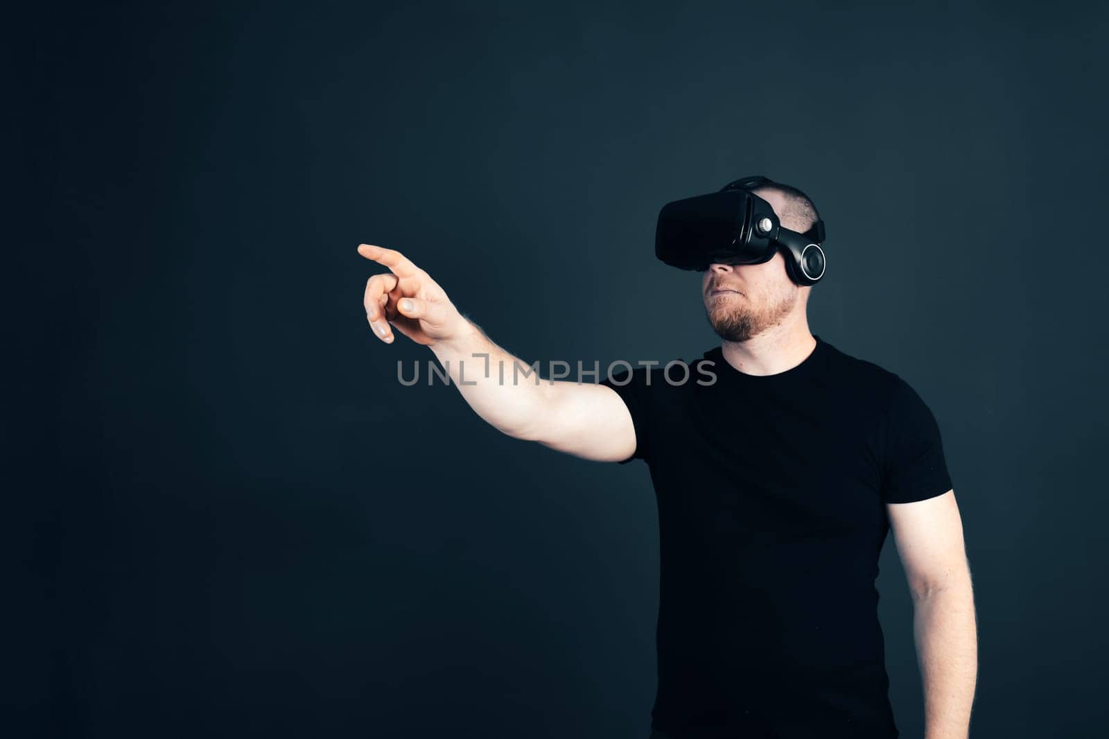 Metaverse digital cyber world technology. Man with VR glasses using AR augmented reality entertainment. NFT, game, futuristic lifestyle.