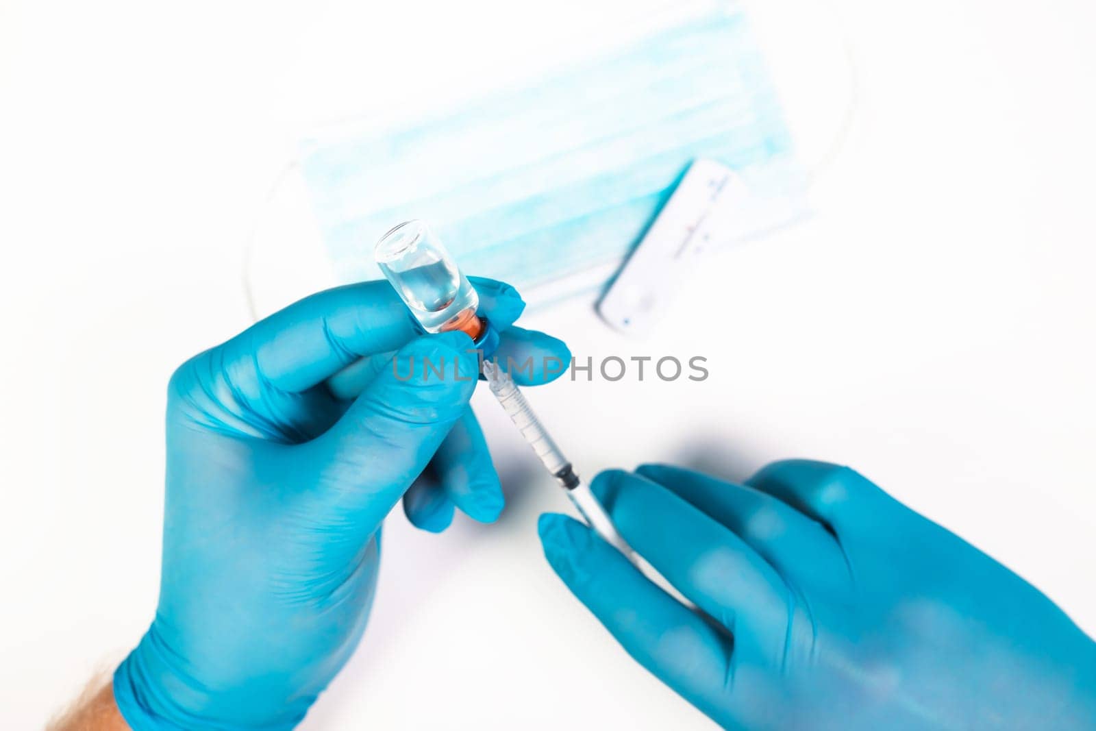 Flat lay of vaccine, test and medical mask. The concept of prevention during Coronavirus pandemic.