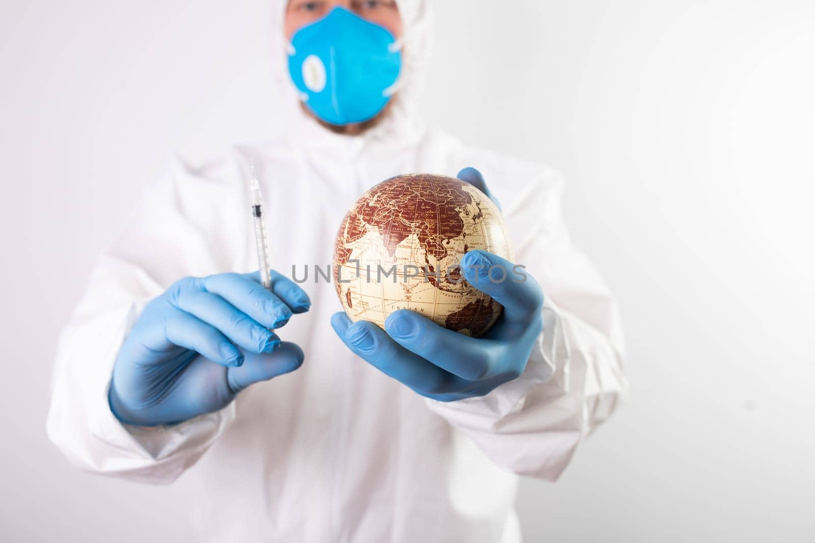 Doctor hand wear blue medical gloves holds antivirus face mask for pandemic diseases. Outbreak, Covid19 concept