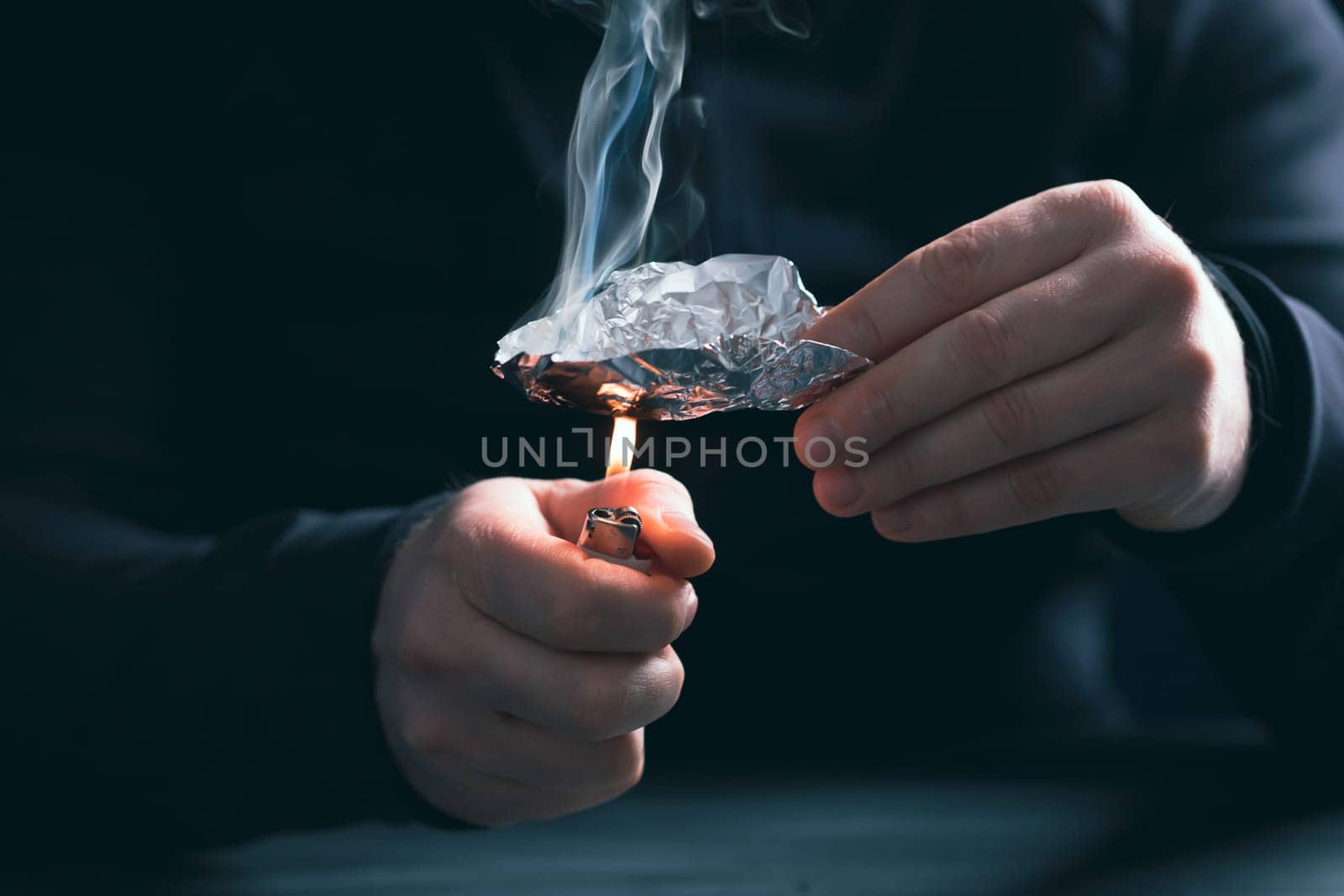Addict/junkie man preparing drugs. The concept of crime and drug addiction.