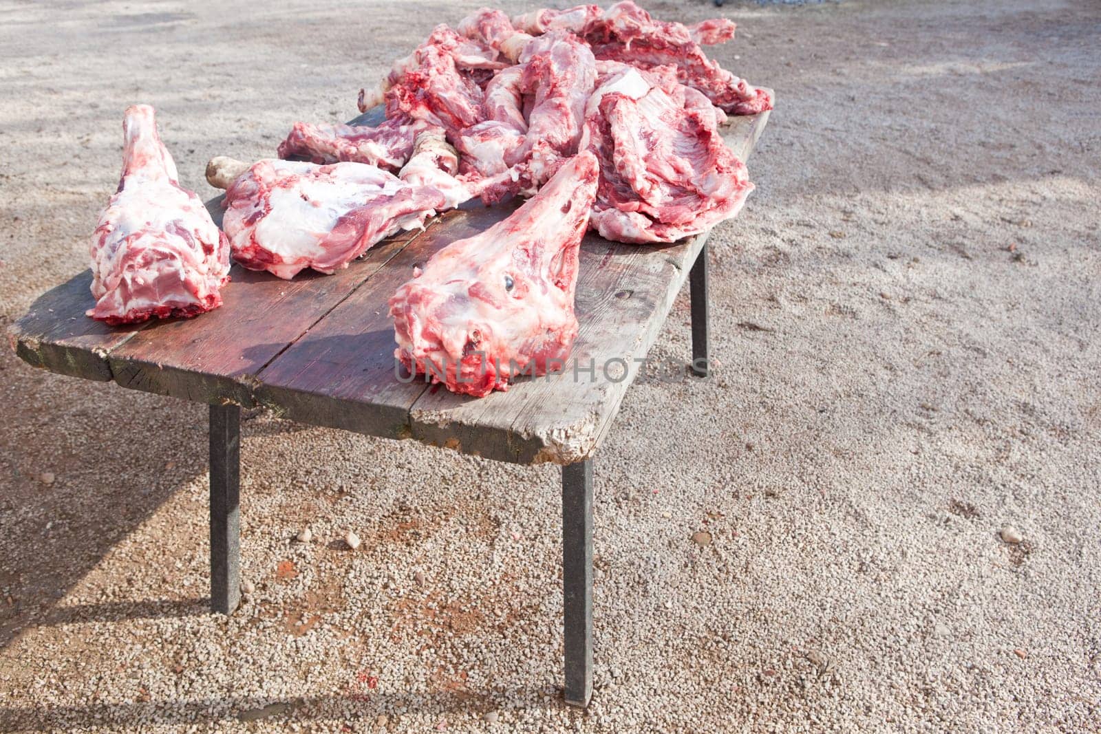 Pieces of pig over wooden table. Traditional home slaughtering in a rural area, Extremadura, Spain