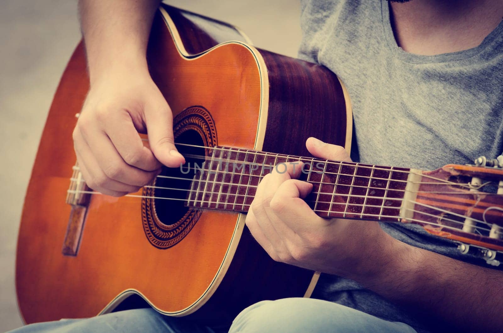 man plays the guitar on the street. retro style.