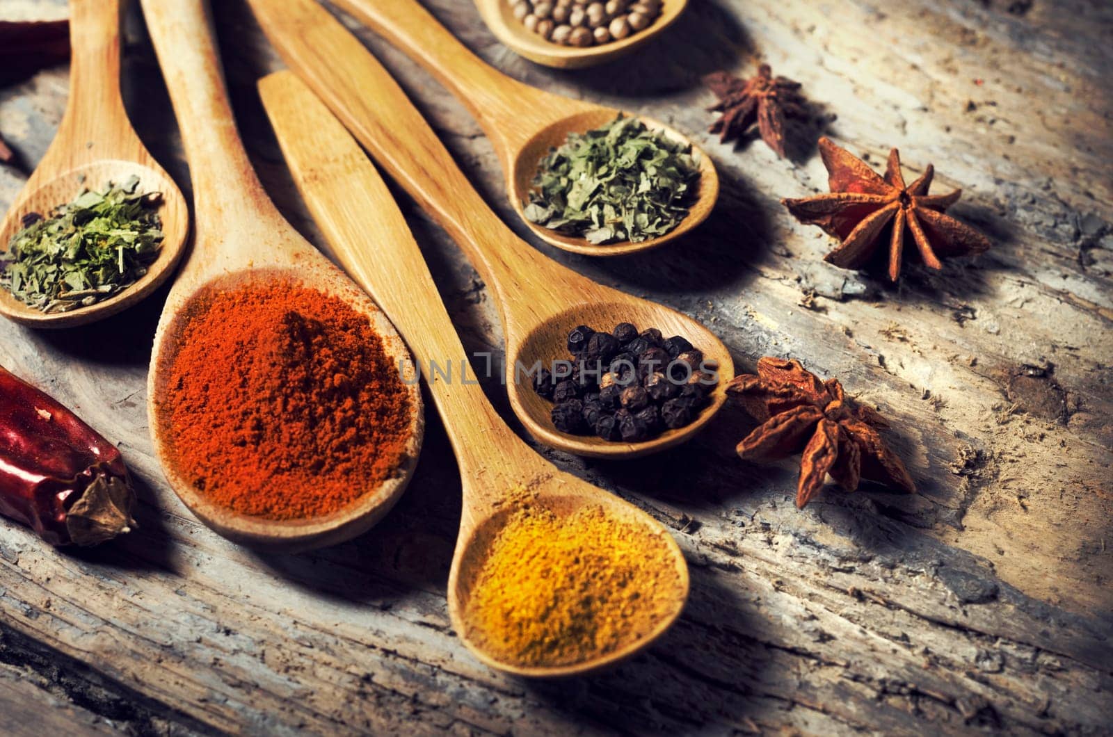 Colorful spices on rustic wooden table