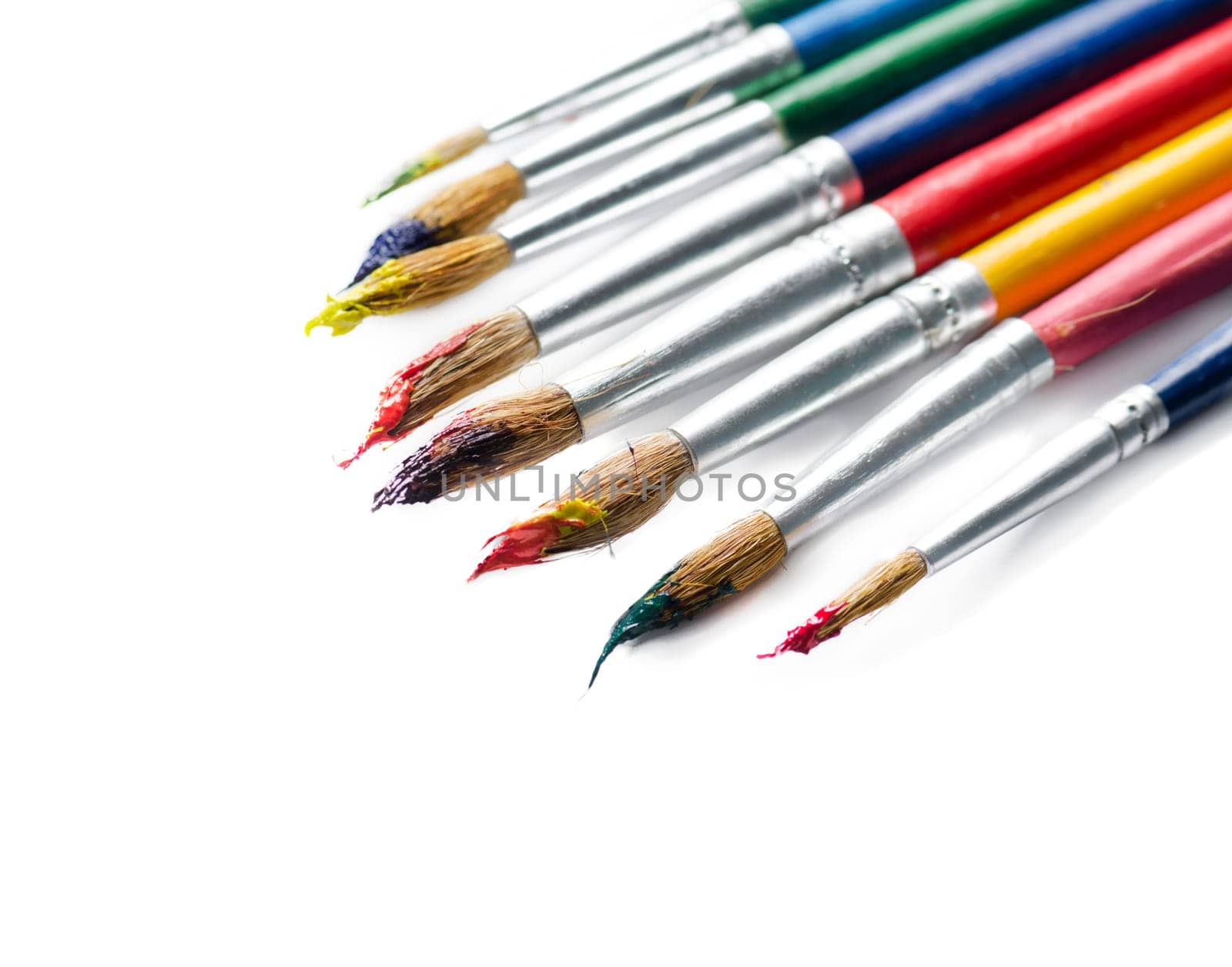 Colorful paint brushes isolated over white