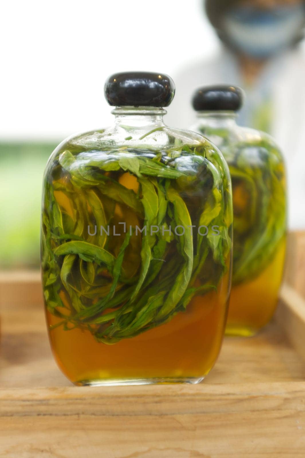 Dried cannabis pickled with honey in bottle .