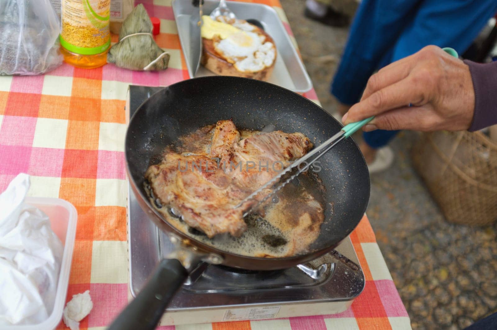 Fried pork in pan .  THAI FOOD