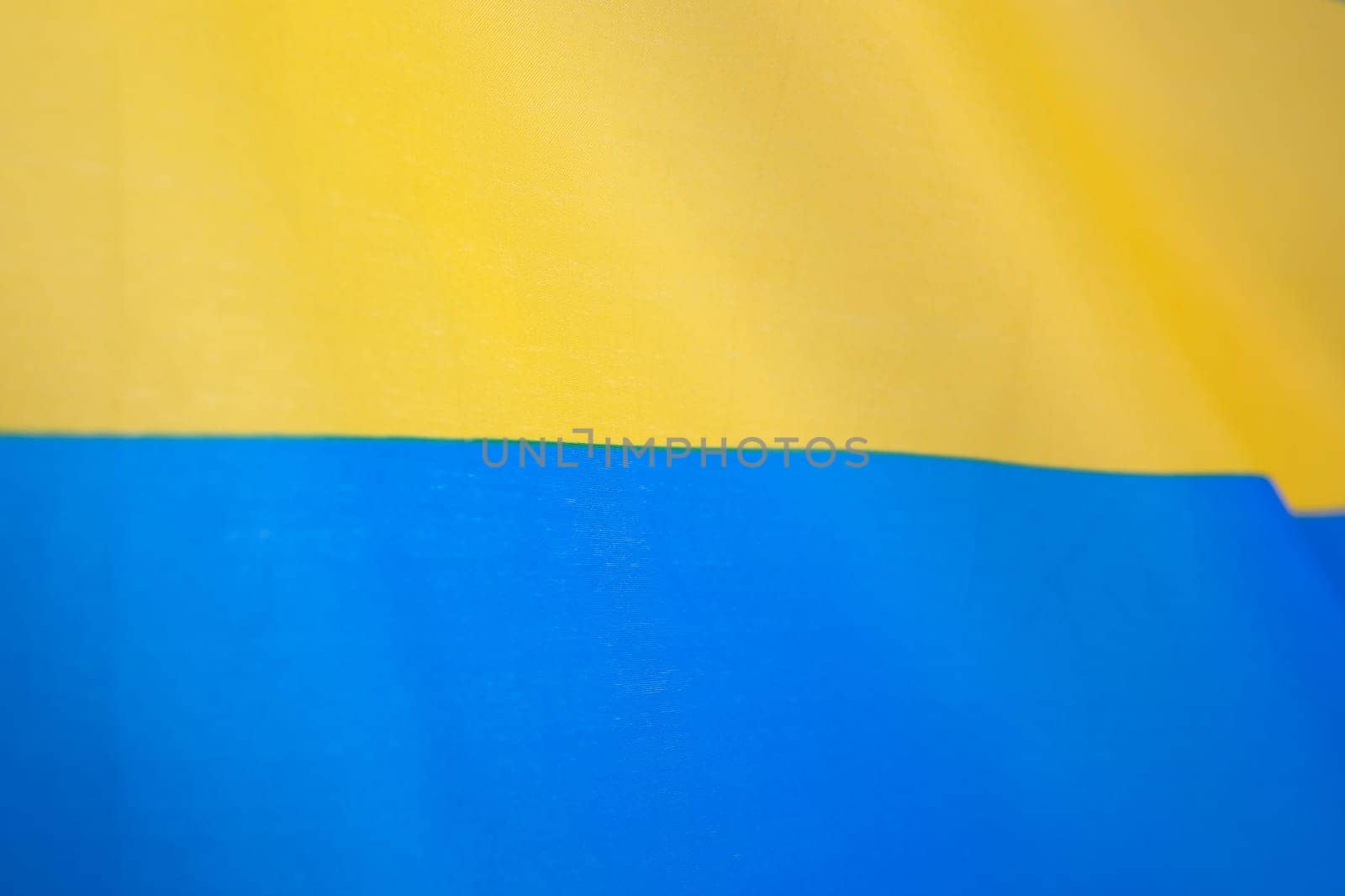 Flag of Ukraine, UA. Blue and yellow colors. Close up shot, background