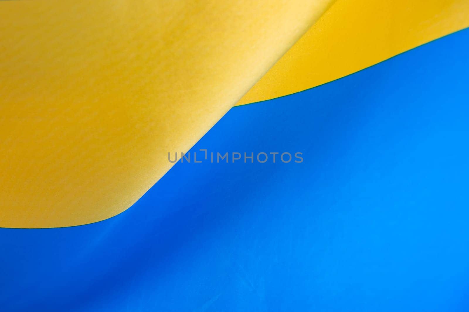 Flag of Ukraine, UA. Blue and yellow colors. Close up shot, background