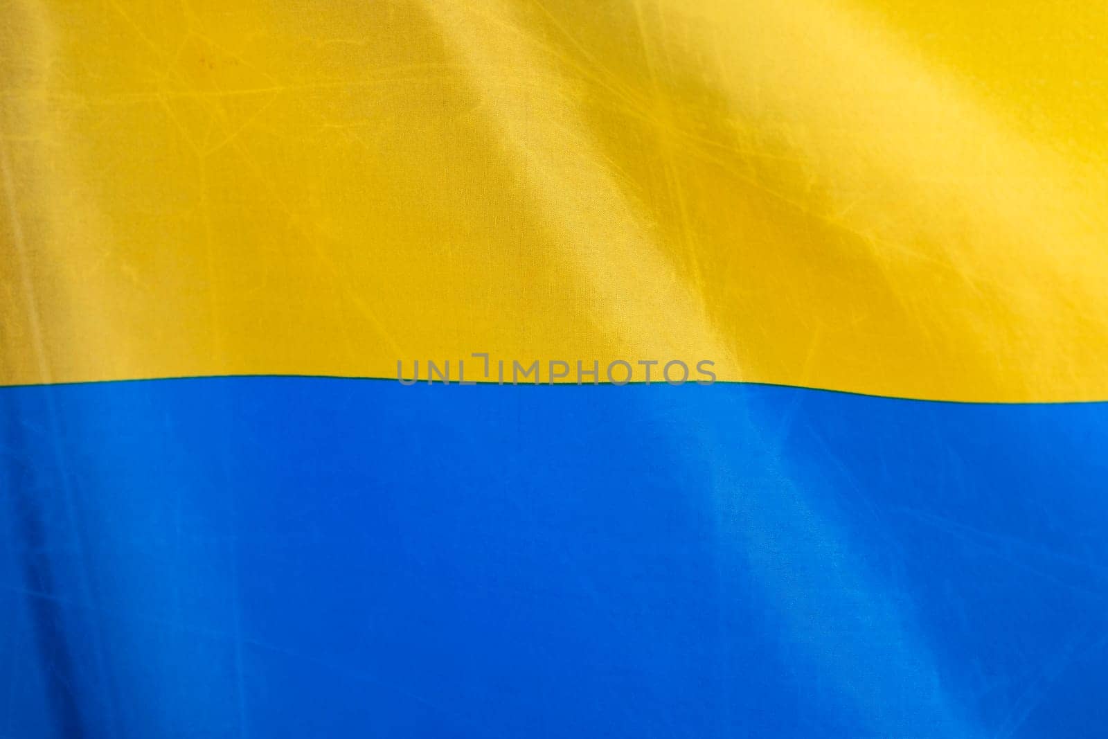 Flag of Ukraine, UA. Blue and yellow colors. Close up shot, background