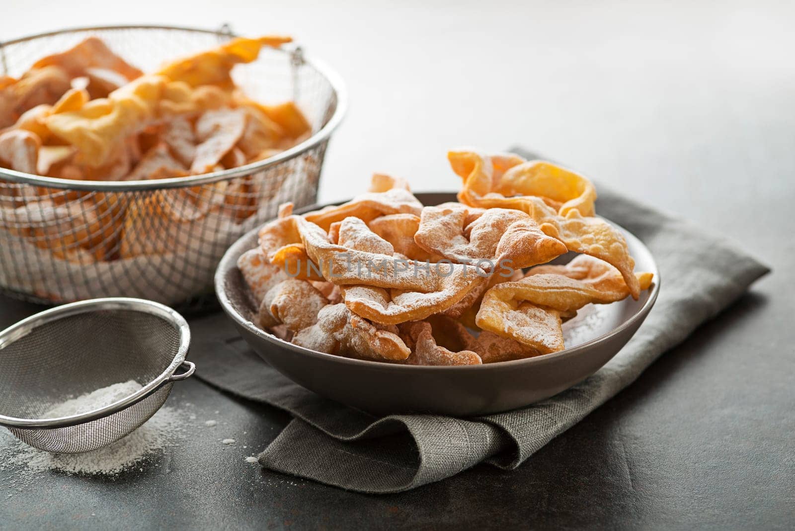 Traditional sweet crisp pastry - faworki or angel wings, deep-fried and sprinkled with powdered sugar