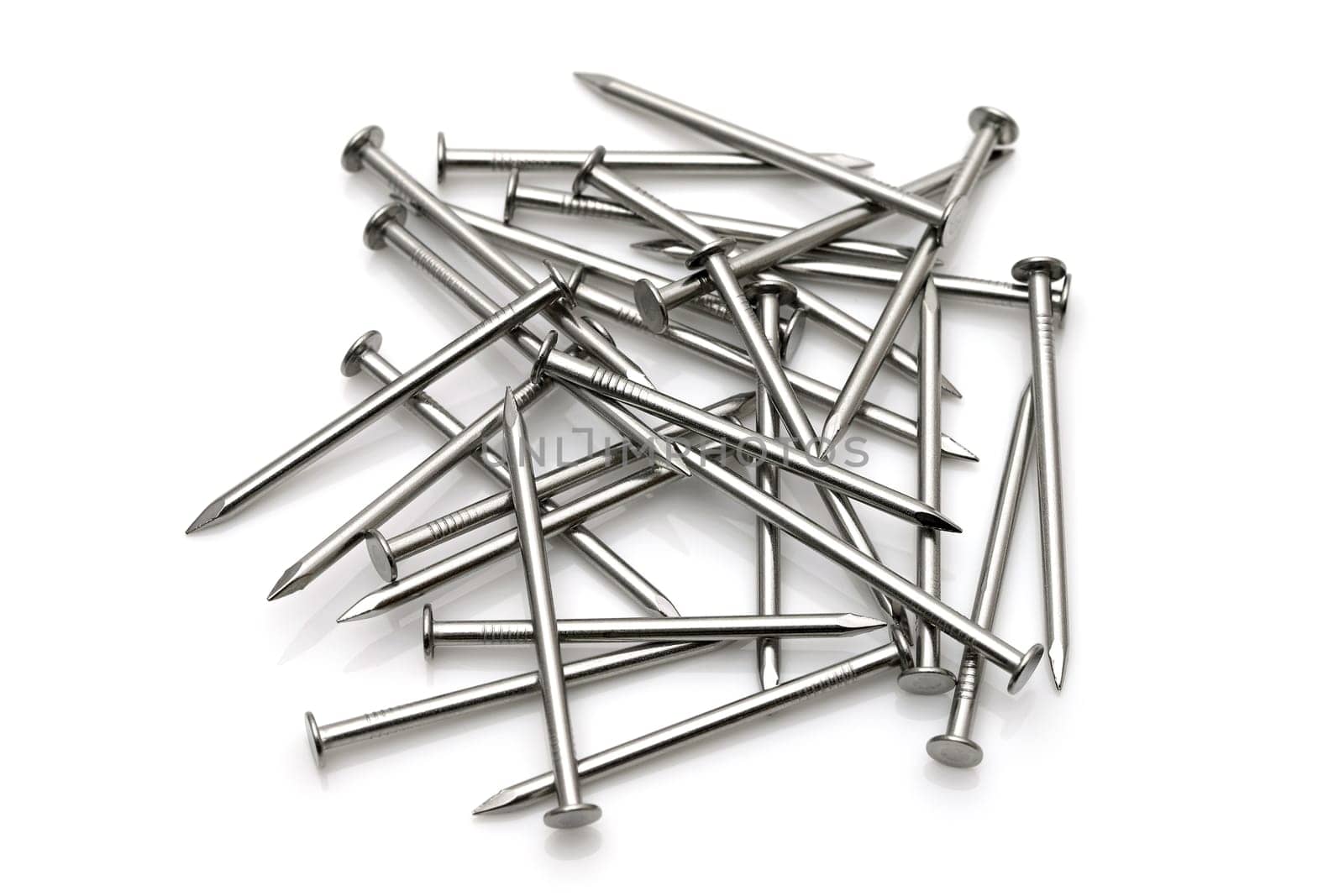 Pile of silver metallic nails isolated on white background
