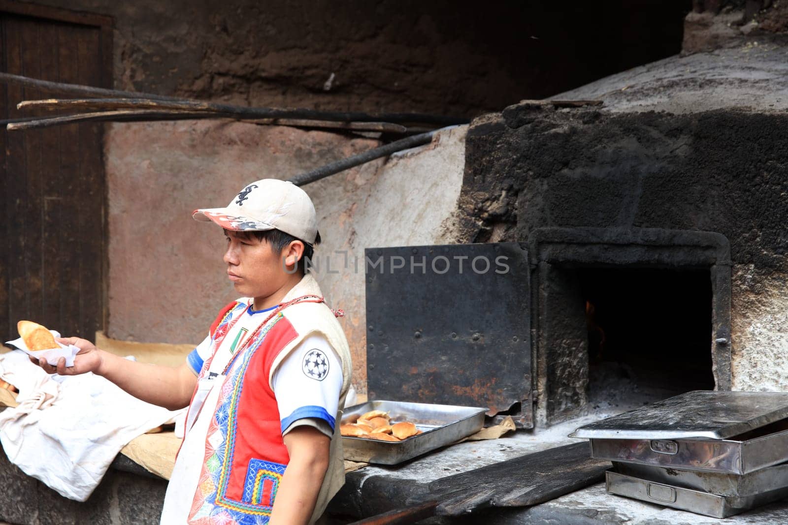 Man at open air Bakery in Pisac. Peru