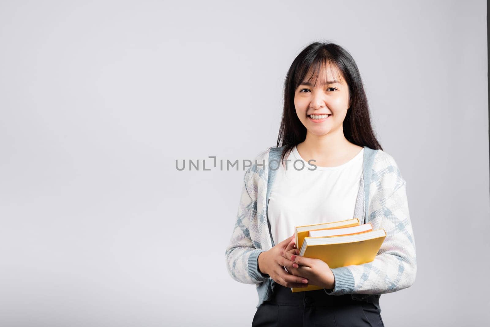 Woman teen smiling holding and hug embrace favorite book for lover, Portrait of beautiful Asian young female person teacher studio shot isolated on white background, education concept