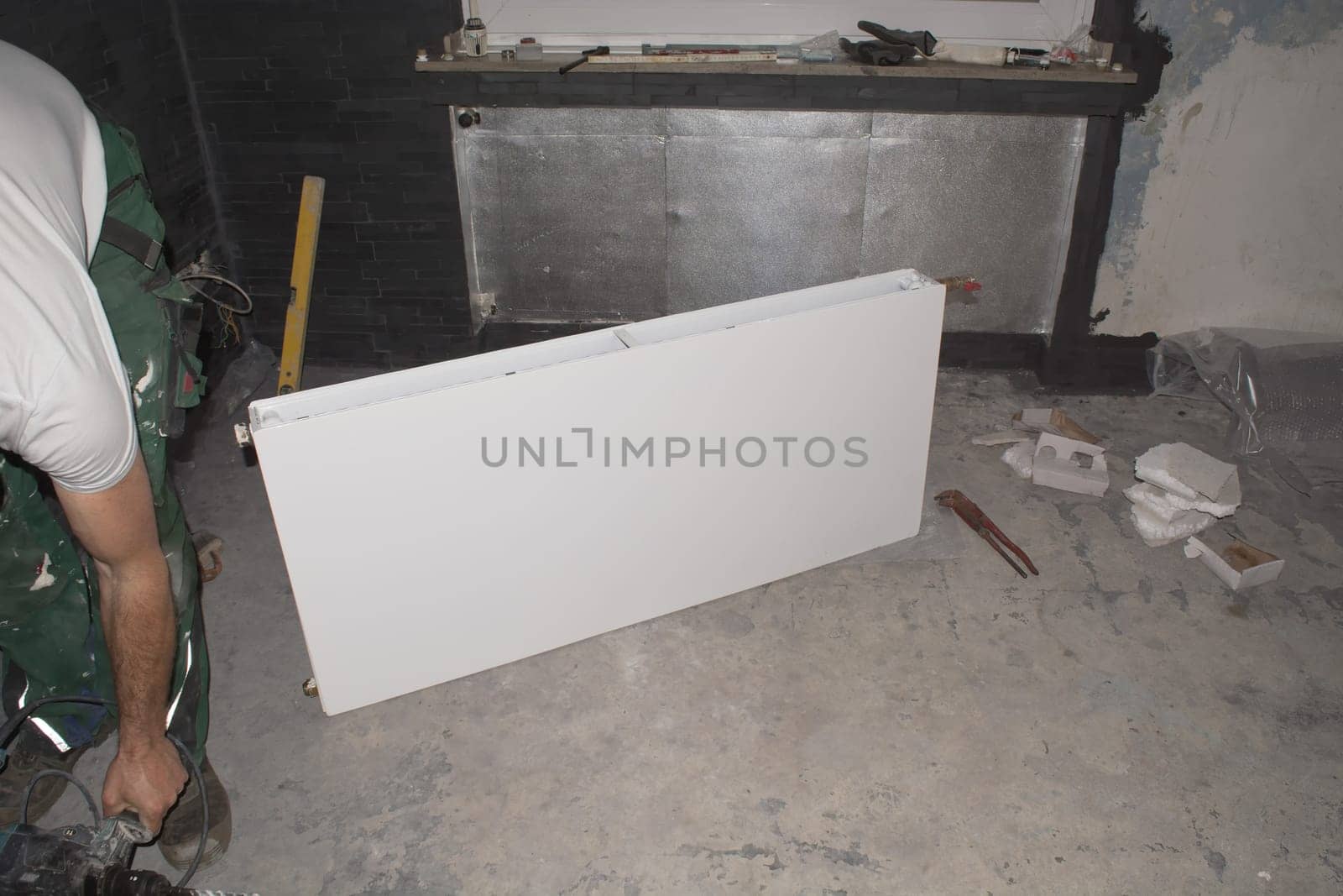 A heating installer installs a heater