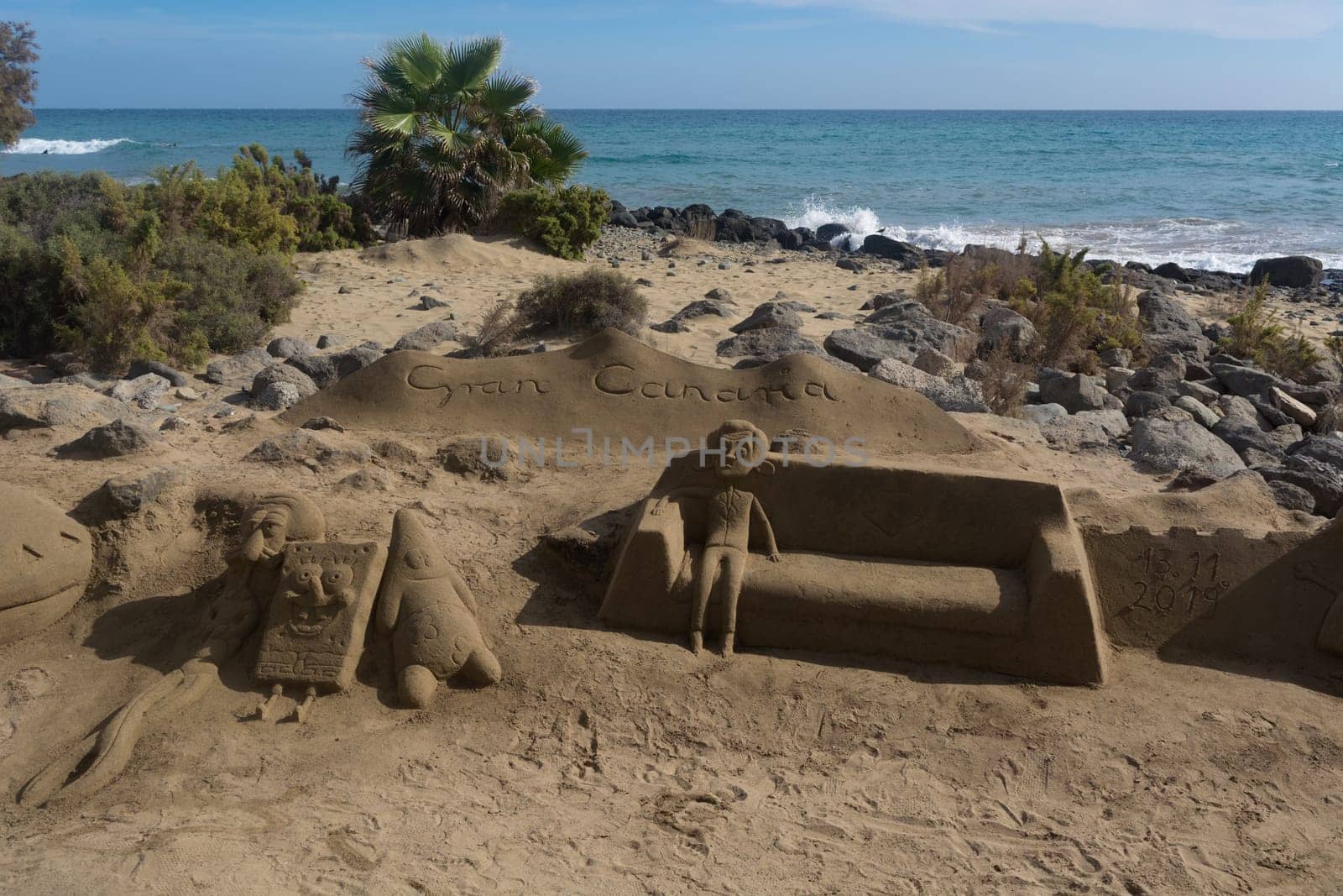 CRAN CANARIA, MELONERAS - 13. NOVEMBER 2019:.Sand sculptures on the beach of Meloneras, Spain with inscription Gran Canaria