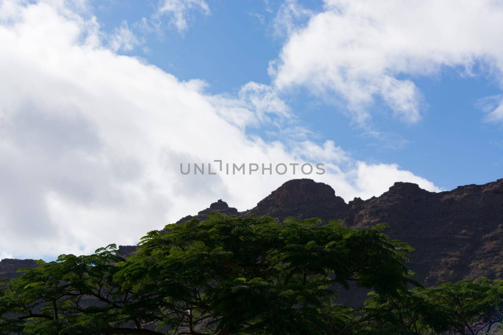 Mountains on the coast between Puerto de Mogan and Puerto Rico. Layers of volcanic rock.