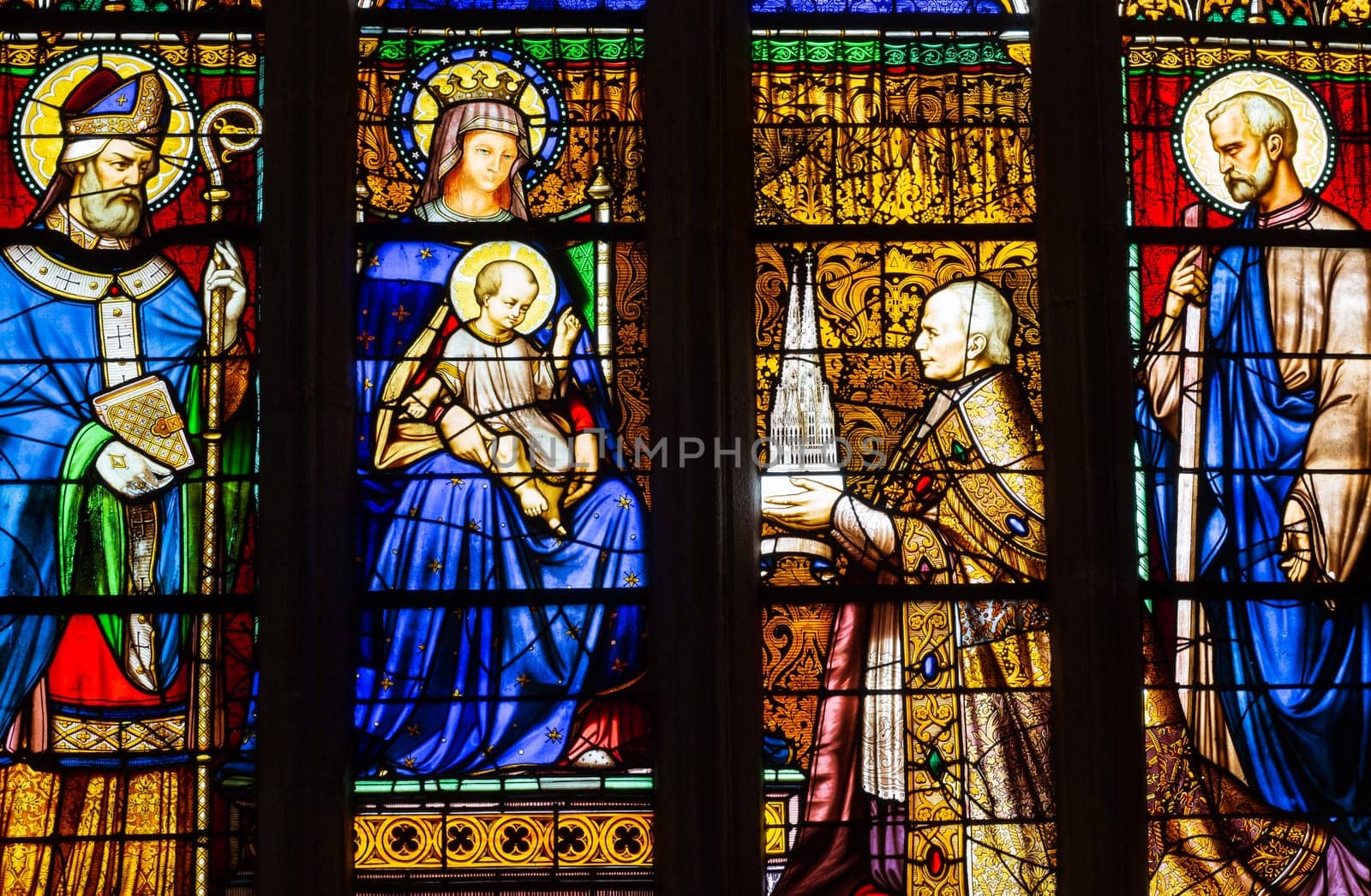 Quimper, Brittany, France - August 11 2017 : Stained glass in the Cathedral of Saint Corentin. Bishop his grace Graveran offering cathedral to Our Lady and St Corentin.