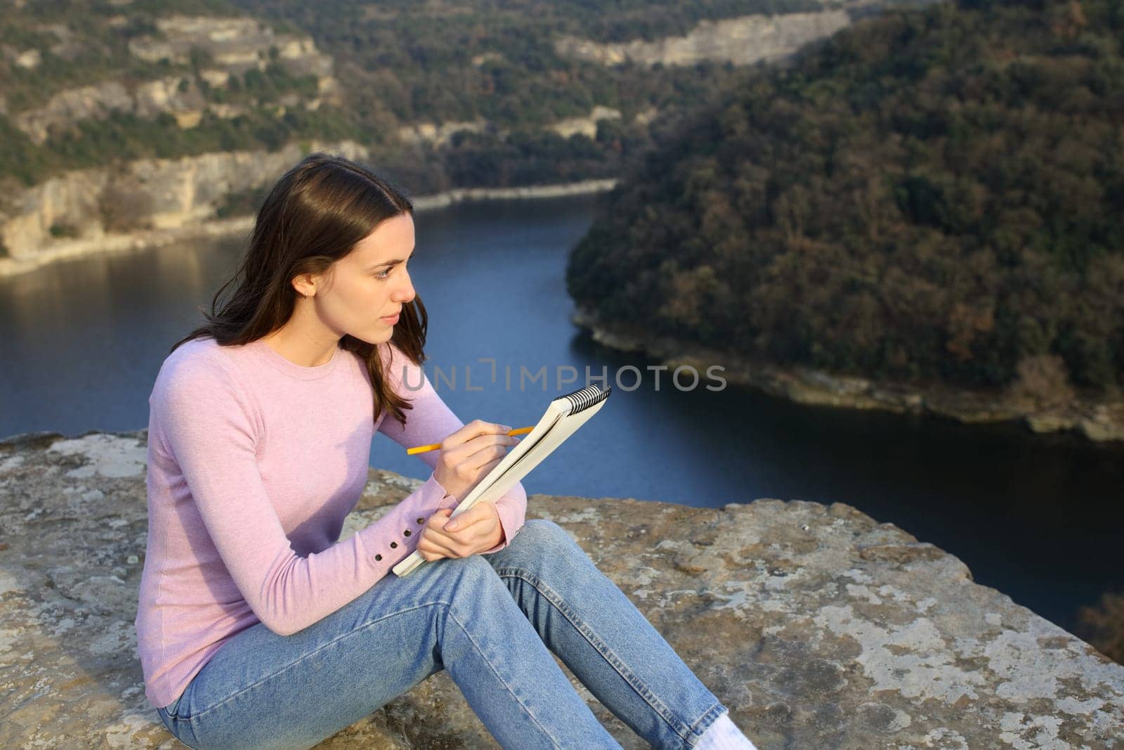 Woman drawing on notebook in nature