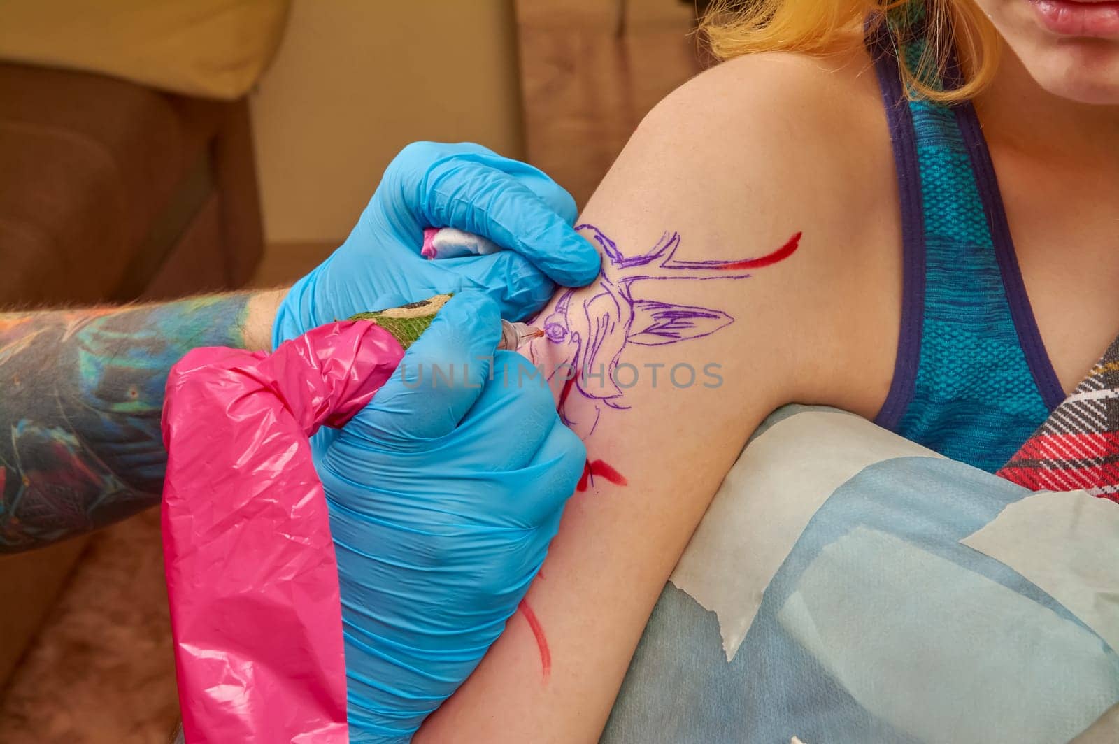 the process of tattooing on the forearm close-up. High quality photo