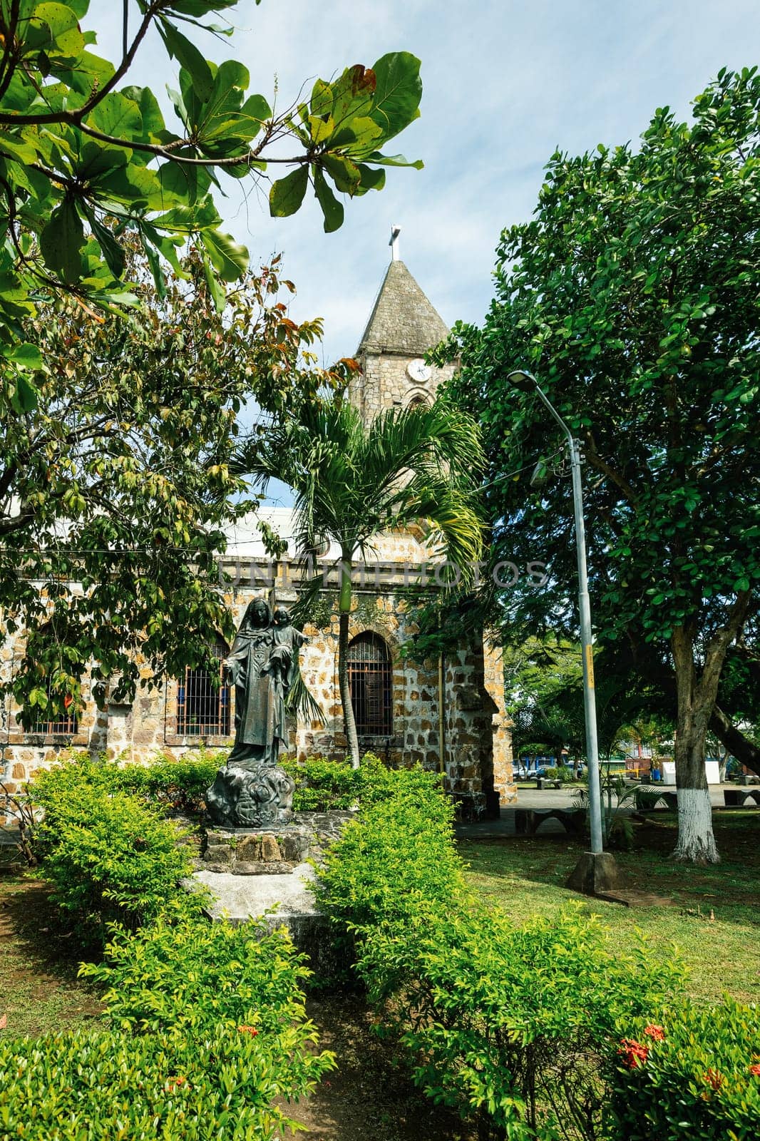 Statue in behind The Our Lady of Mount Carmel Cathedral, Puntarenas Cathedral is a temple of the Roman Catholic church in the city of Puntarenas, Costa Rica