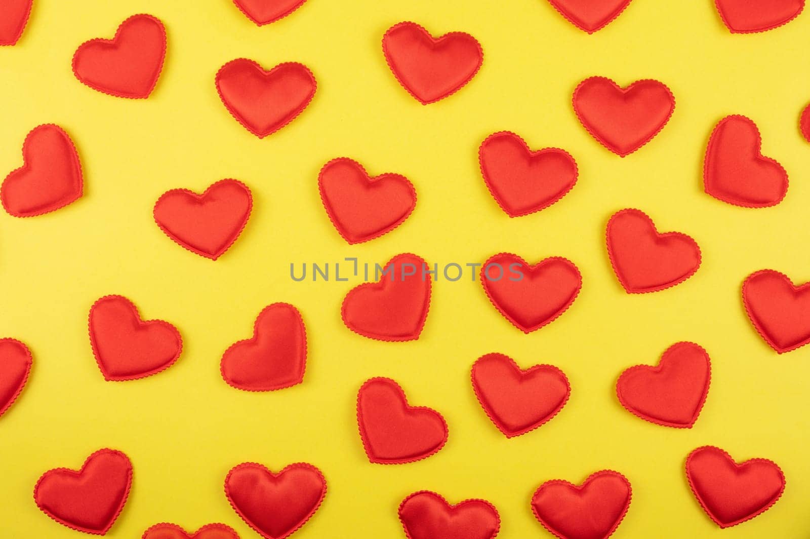 Valentine day yellow paper background with red hearts background. Valentines day or love concept
