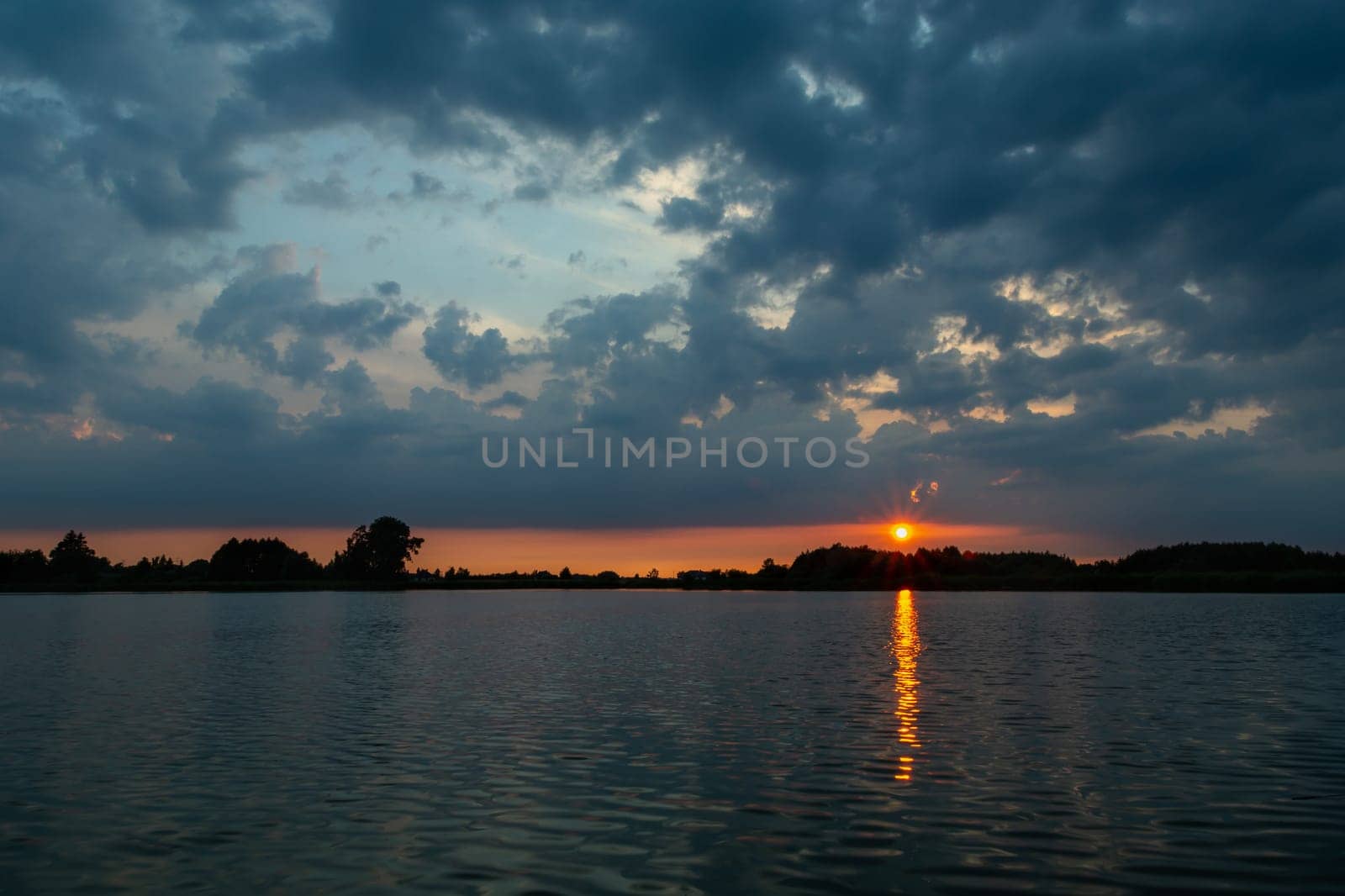 Dark clouds and sunset over the lake, Stankow, Lubelskie, Poland