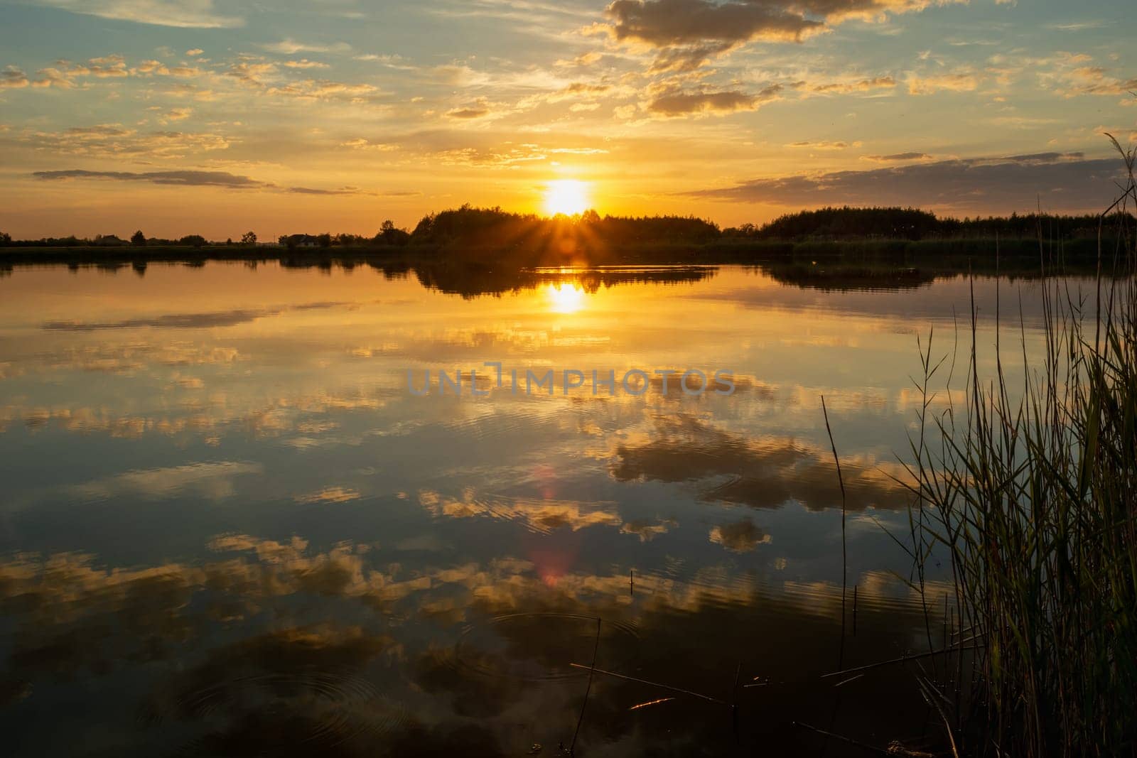Sunset over a quiet lake, spring evening