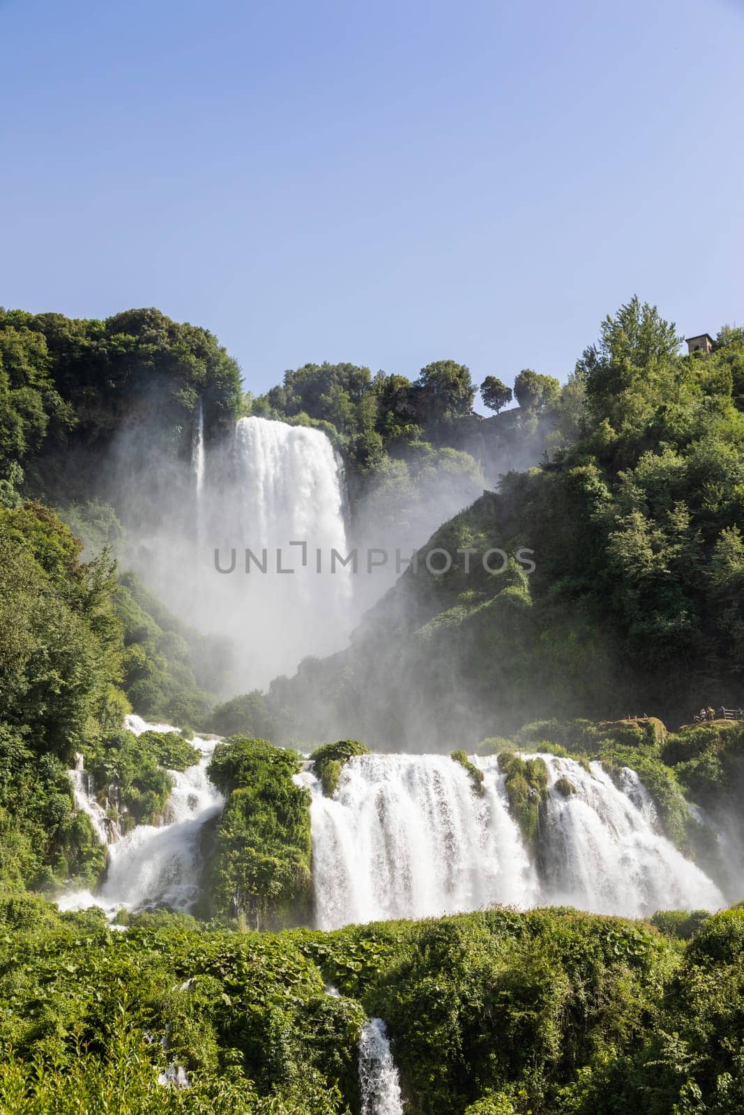 Marmore waterfall in Umbria region, Italy. Amazing cascade splashing into nature with trees and rocks.