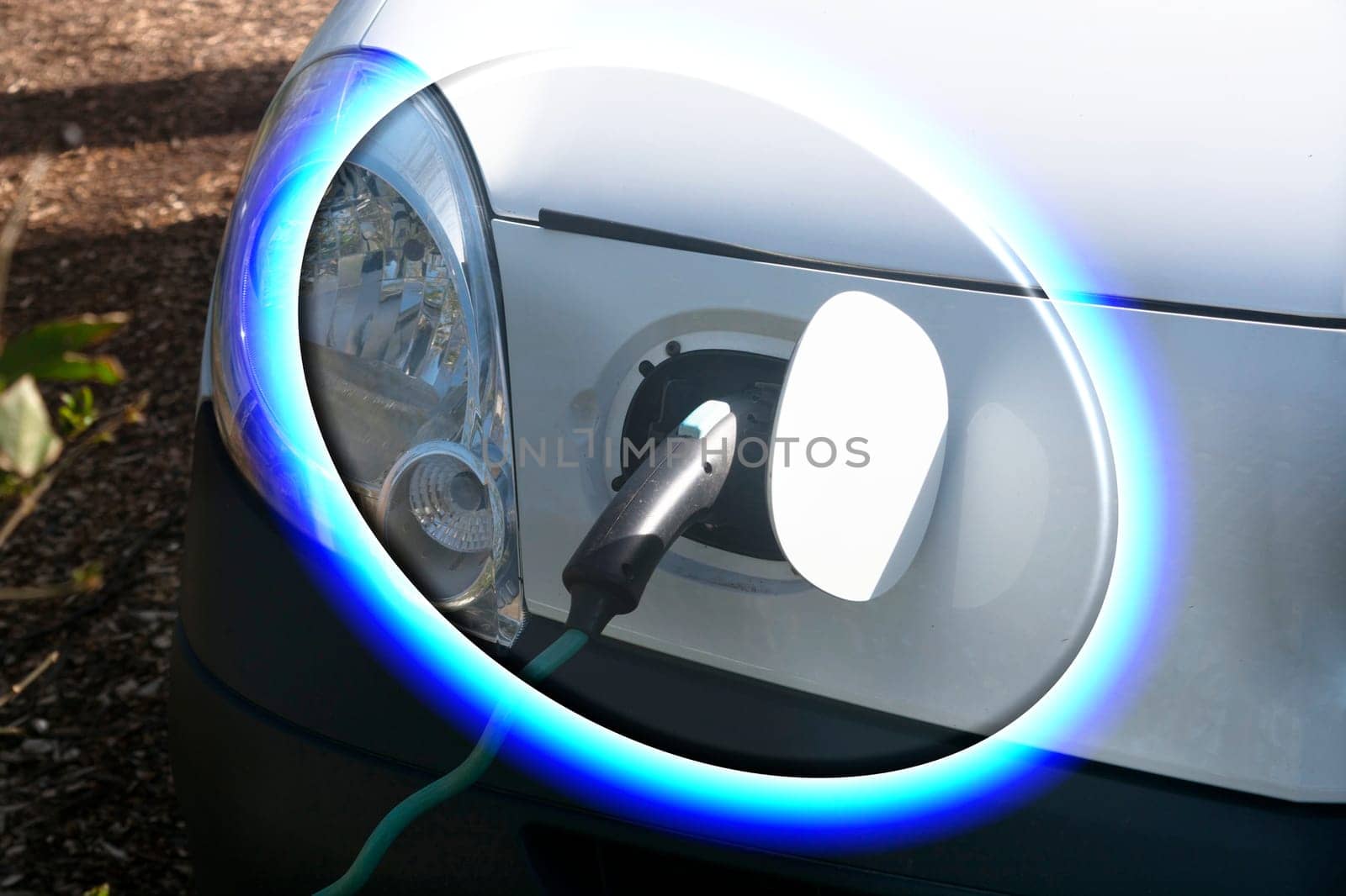 EV car or electric vehicle at the charging station with the power cord adapter plugged into blurred nature with blue energy power effect. Environmentally friendly sustainable energy concept. .