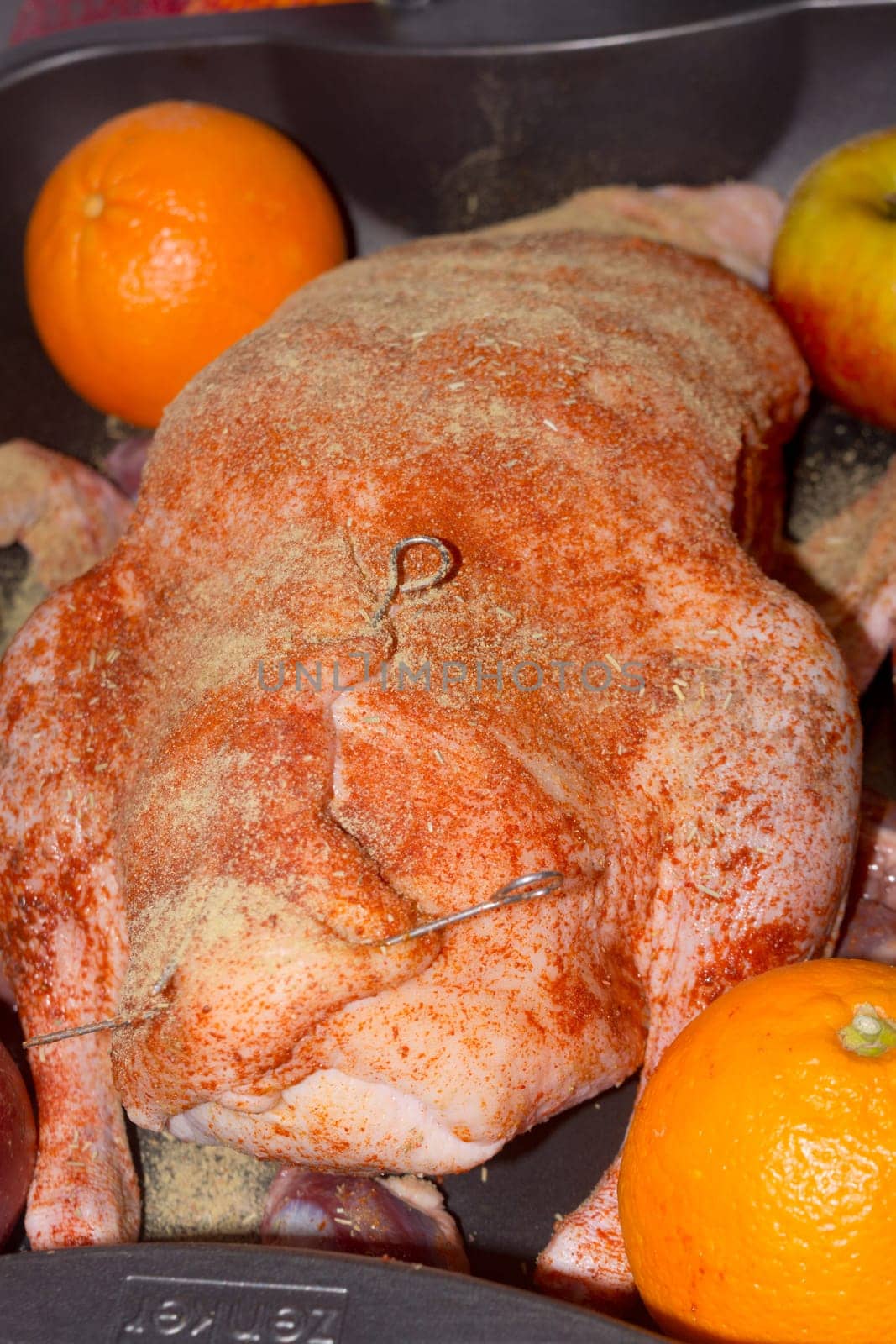 Roast goose stuffed with baked apples and oranges in a frying pan, festive Christmas recipe. Top view with copy space.