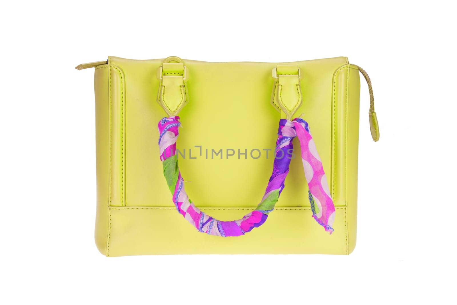 A fashionable female yellow luxury handbag decorated with colorful cloth and isolated on a white background. Fashionable womans accessories. Advertising.