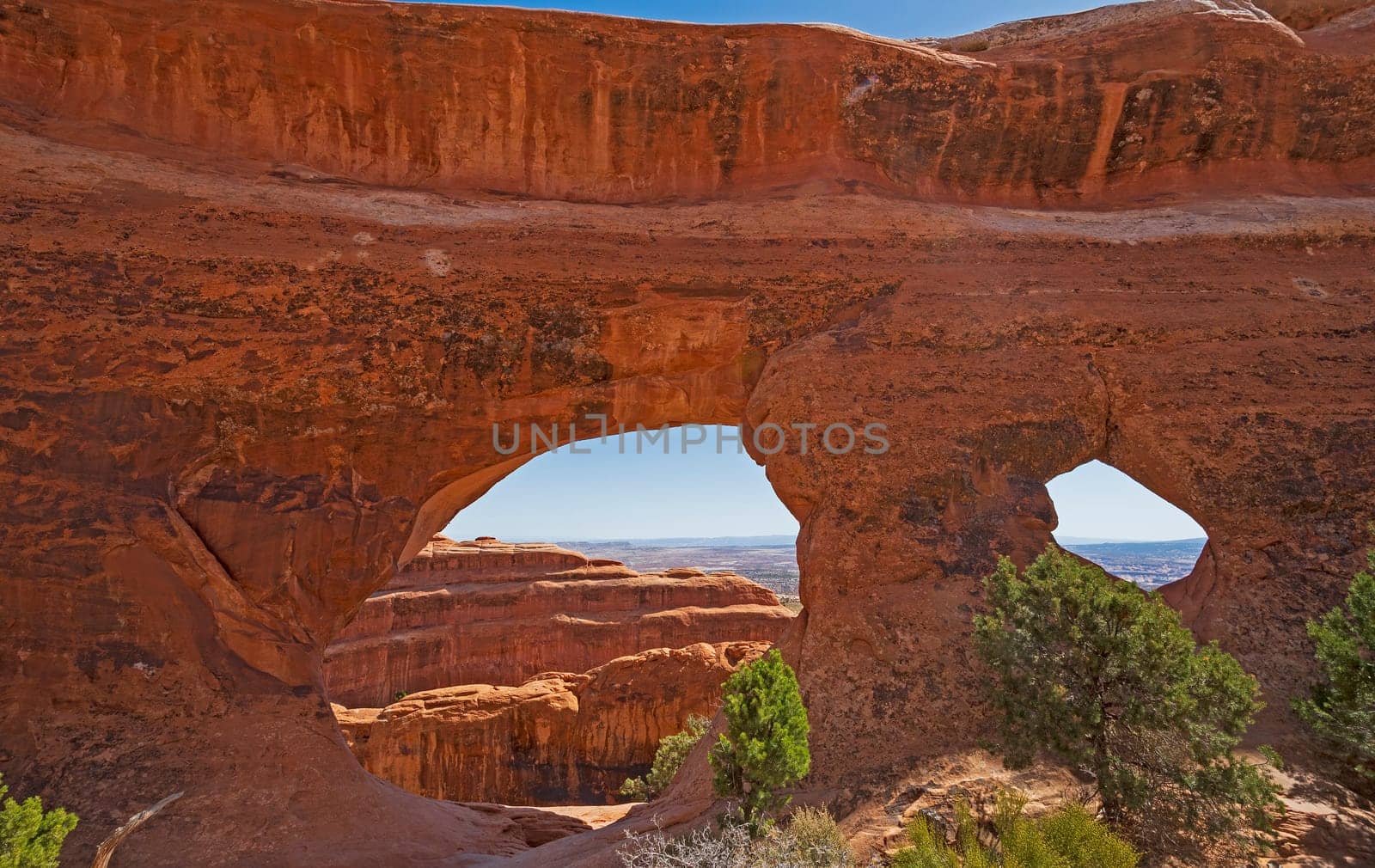Looking Through a Pair of Arches on Partition Arch in Arches National Park in Utah