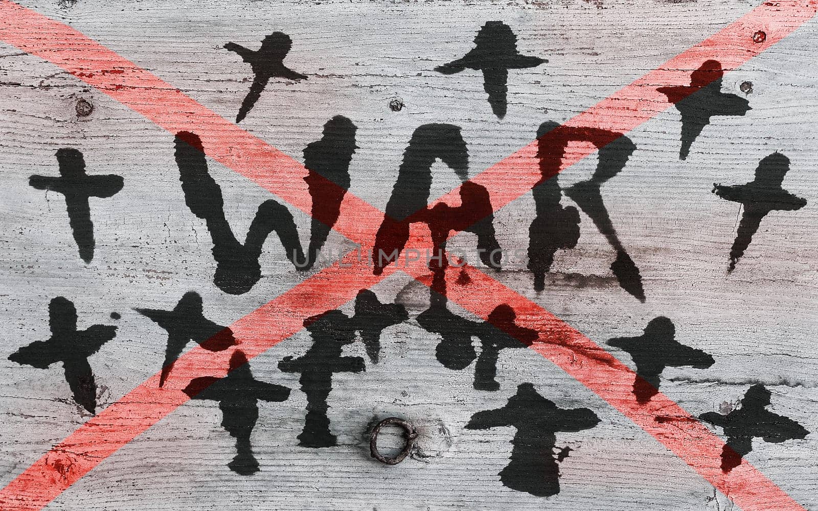 War. A wooden sign with the inscription WAR crossed out and crosses