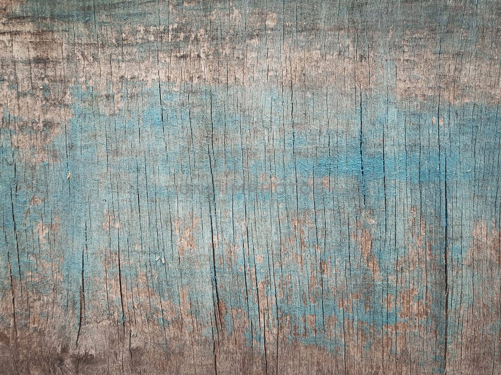 Old wooden texture with blue abstract paint. Grunge plank or plywood surface background