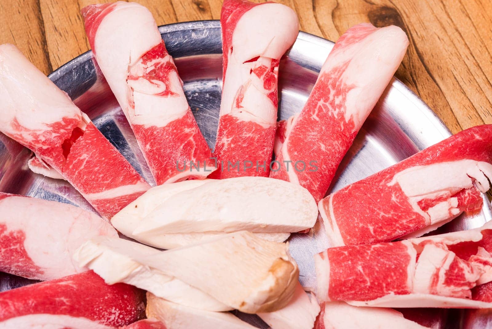 Raw pork on plate, Korean traditional style fresh pork beef belly BBQ, Japanese meat hot pot or Shabu in the restaurant, barbecue food