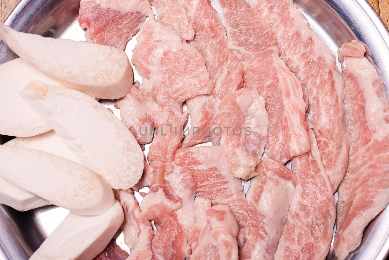 Raw pork on plate, Korean traditional style fresh pork beef belly BBQ, Japanese meat hot pot or Shabu in the restaurant, barbecue food