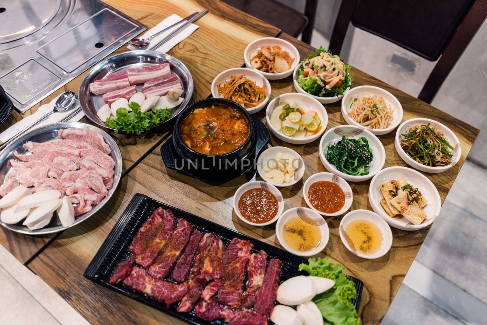 Korean BBQ set. Beef for grill on stove serve with vegetable and soup wood table , Japanese food style barbecue